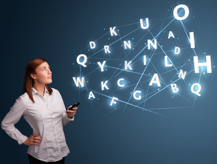 Young woman typing on smartphone with high tech 3d letters commi