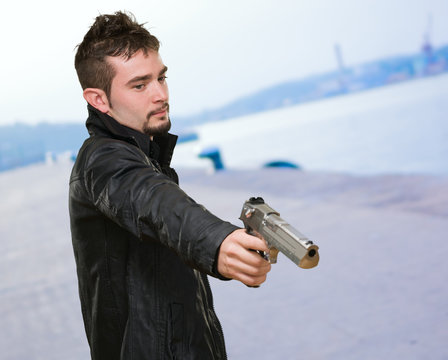 Portrait Of A Man Holding Gun