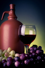 vine glass and bottle and red grapes