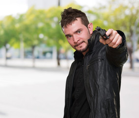 mad man pointing with gun