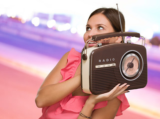 Portrait Of Happy Woman Holding Radio