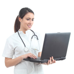 Beautiful nurse typing in a laptop