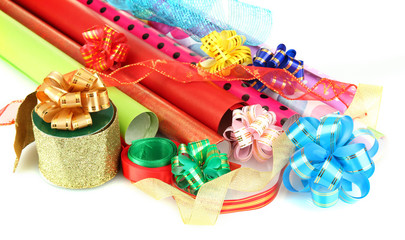 Rolls of Christmas wrapping paper with ribbons, bows isolated