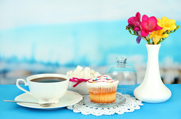 Cupcake on saucer with glass cover, on bright background