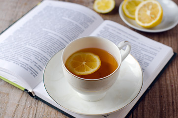 Tea with lemon in an open book