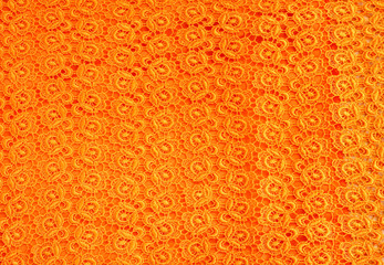 Detail of orange lace pattern fabric