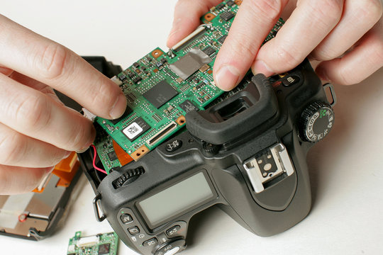 Man repairs digital camera