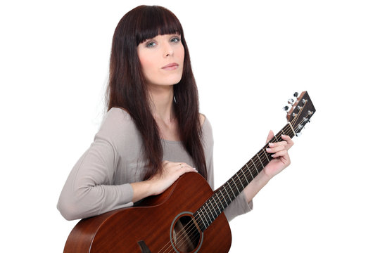 Woman playing acoustic guitar