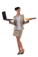 Woman holding laptop and documents