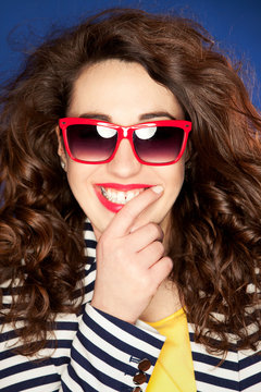 Beautiful happy young woman wearing sunglasses