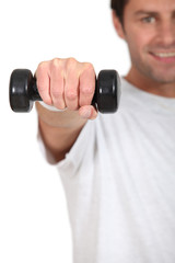 Naklejka premium Young with weights in hand