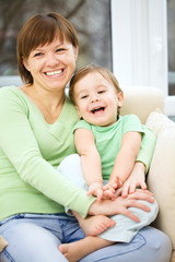 Mother and her son are watching tv