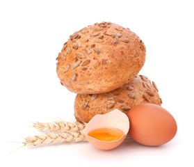 Bun with seeds and broken egg