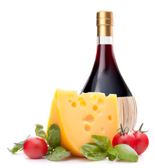 Red wine bottle, cheese and tomato still life