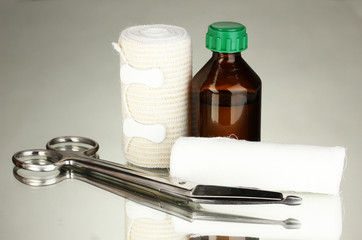 First aid kit for bandaging on grey background