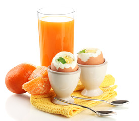 Light breakfast with boiled eggs and glass of juice, isolated