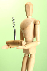 Mannequin with corkscrew, on green background