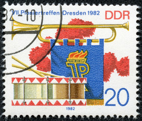 stamp printed in GDR shows Bugle, Pennant and Drum
