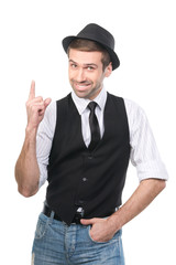 Smiley young casual man in hat gesturing attention forefinger. I