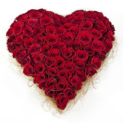 composition of red roses in the shape of heart isolated on white