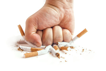 Human fist breaking cigarettes on white background