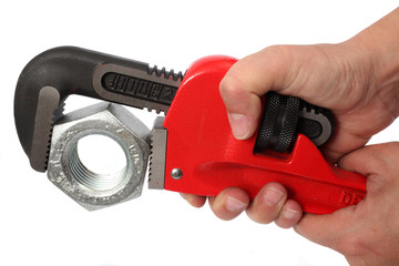Hands turning a hardware nut with a wrench