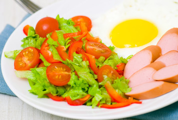 breakfast. salad, egg and sausage