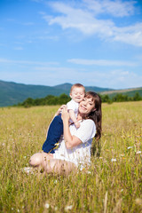 Fototapeta premium Family - happy mom and her son smiling at nature