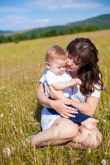 Fototapeta premium Family - happy mom and her son smiling at nature