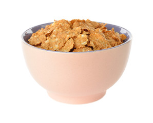 Wheat flakes in a bowl on a white background
