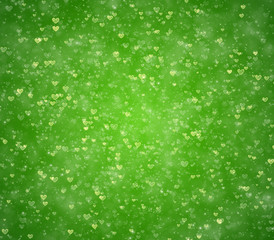 Hearts and particles on a green background