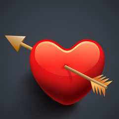 Glossy Red heart with golden bow on grey background.