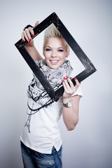 portrait of a smiling young woman posing with black frame