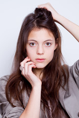 portrait of young beautiful woman with hand on cheek