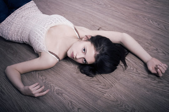 portrait of a pretty young woman lying on the floor