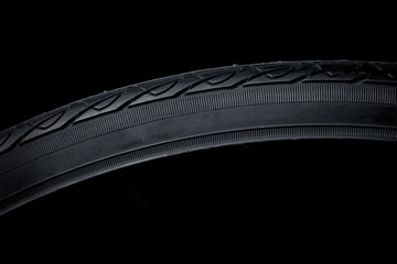 Close up of a bike tire detail on black background