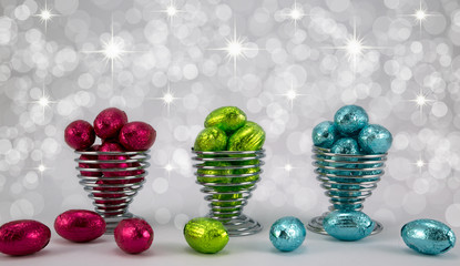 Easter eggs in wire eggcups.