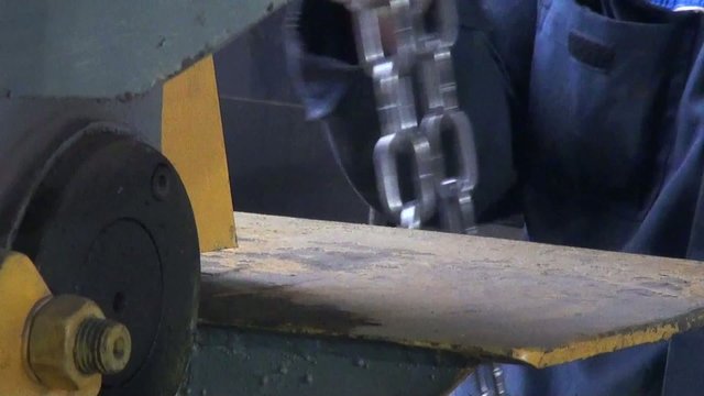 man working at the factory with a chain