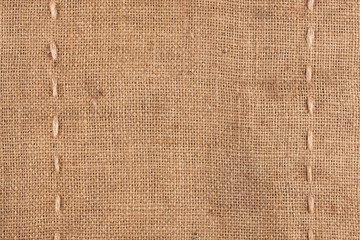 The two vertical stitching on the burlap - obrazy, fototapety, plakaty