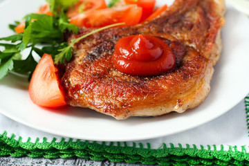 Pork chop with ketchup and vegetables