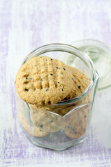 Orange and black sesame cookies in jar