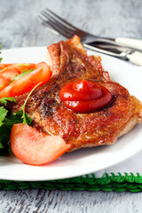 Pork chop with ketchup and vegetables