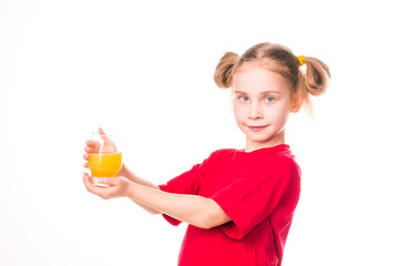 Cute little girl holding glass with juice smiling
