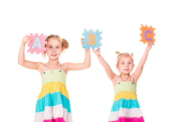 Happy kids holding alphabet letters ABC