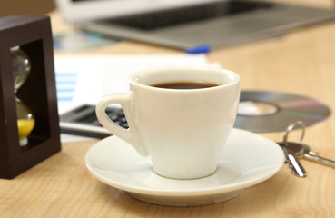 Cup of coffee on office desktop close-up