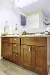 New bathroom interior with cherry sink cabinet.