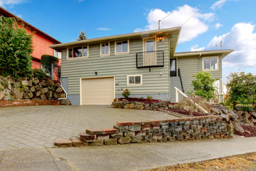 Grey green newly remodeled two level house exterior.