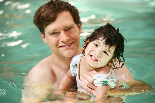 Father And Toddler Boy Swimming