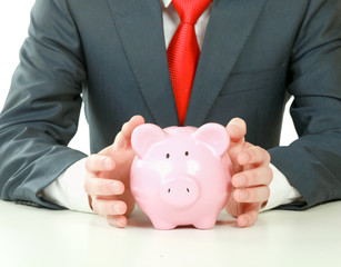 Young man with piggy bank (money box)