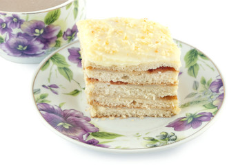 piece of cake with a cup of coffee on a white background